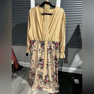 Floor length, long sleeve dress. Beige with a floral skirt.